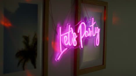 Close-Up-Of-Neon-Let's-Party-Sign-Hanging-On-Wall-At-House-Party