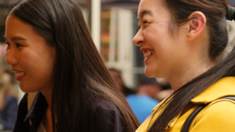 Close-Up-Of-Two-Women-Buying-From-Street-Food-Market-Stall