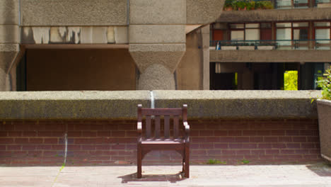 Wooden-Seat-Inscribed-City-Of-London-Outside-Residential-Apartments-In-The-Barbican-Centre-In-London-UK