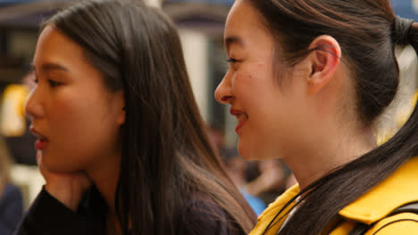 Close-Up-Of-Two-Women-Buying-From-Street-Food-Market-Stall-1