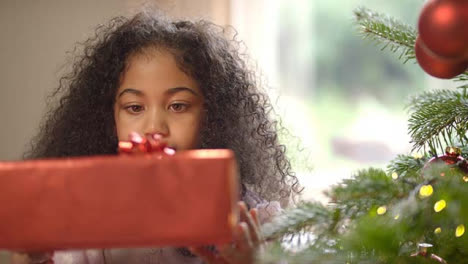 Inquisitive-Child-Holding-Christmas-Present