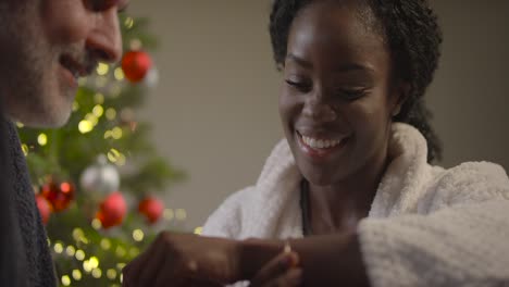 Woman-Putting-on-Bracelet-at-Christmas