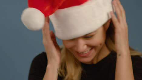 CU-Woman-Flicks-Head-with-Santa-Hat