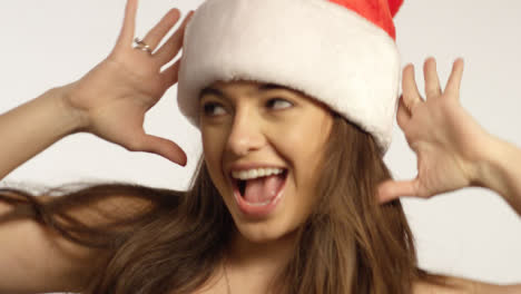 CU-Woman-Wearing-Santa-Hat-Sings-To-Camera