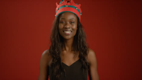Young-Woman-Puts-Christmas-Elf-Hat-On