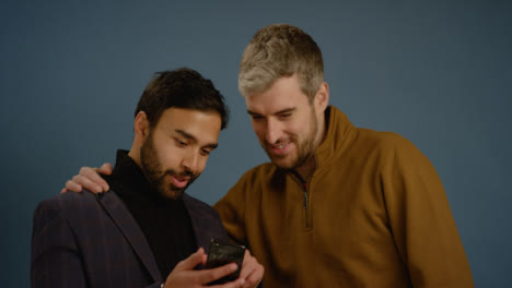 Two-Men-Scroll-Through-Phone