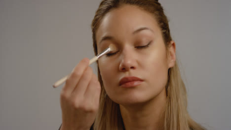 CU-of-Young-Woman-Applying-Eyeshadow