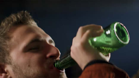 Young-Man-Drinks-Beer-from-Bottle