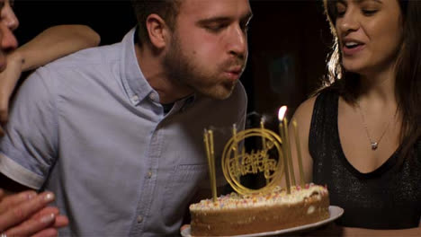 Young-Man-Blows-Out-Birthday-Cake-Candles