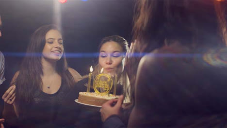 Young-Woman-Blows-Out-Birthday-Candles