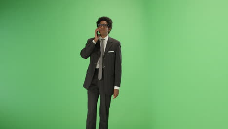 Man-in-suit-talking-on-phone-with-green-screen
