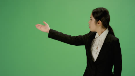 Business-woman-gesturing-with-arms-on-green-screen