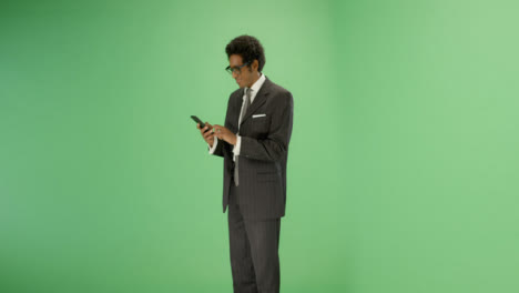 Businessman-texting-on-phone-with-green-screen