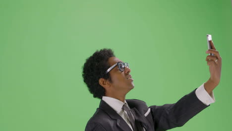 CU-Businessman-trying-find-phone-signal-on-green-screen