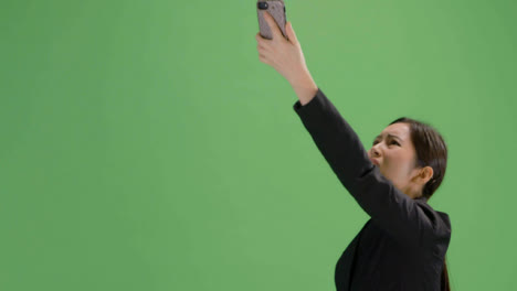 CU-Angry-woman-trying-find-phone-signal-on-green-screen