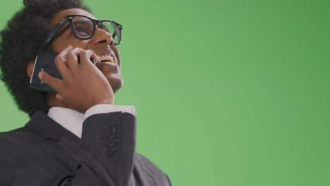 Happy-Businessman-talking-on-phone-on-green-screen-Low-Angle