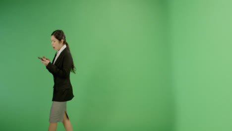 Annoyed-Woman-Texting-While-Walking-on-Green-Screen