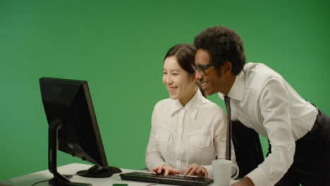 Happy-Businessman-Checking-on-Woman-at-Computer