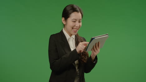 Laughing-Businesswoman-Uses-Tablet-on-Green-Screen