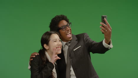 Smiling-Colleagues-Taking-Seflie-on-Green-Screen