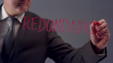 Businessman-Writing-Word-Redundancy