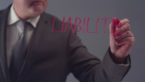 Businessman-Writing-Word-Liabilities