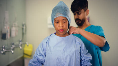 Medics-Putting-On-Surgical-Gown