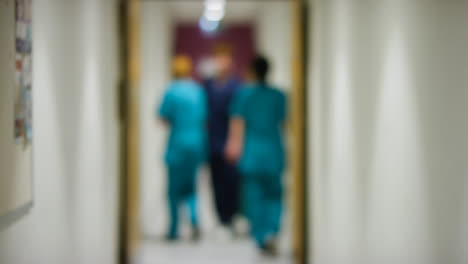 Blurred-Medical-Staff-In-Hospital-Corridor