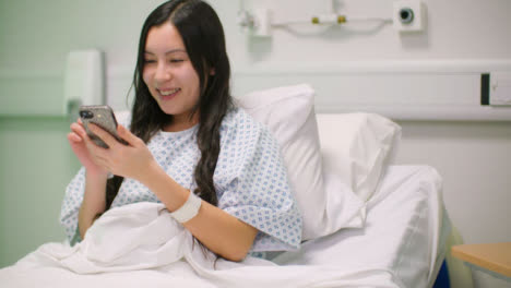 Female-Hospital-Patient-Using-Phone