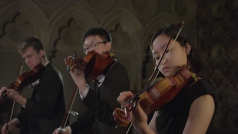 Three-Violinists-Playing-in-Sync