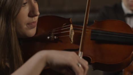 Close-Up-Pan-Of-Female-And-Male-Violinist-During-A-Performance