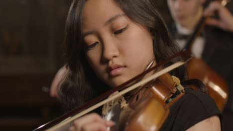 Close-Up-Pan-To-Female-Violinist-During-Performance