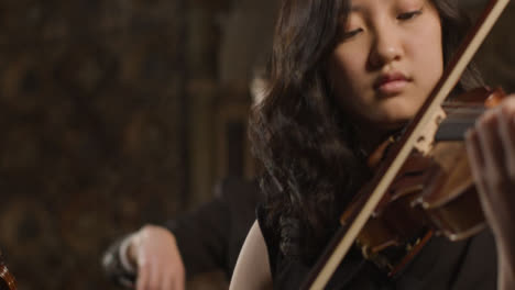 Pan-Up-To-Female-Violinist-During-Performance