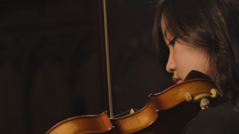 Side-View-Close-Up-Female-Violinist-During-Performance