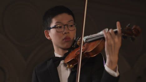 Pan-Of-Male-Violinist-During-Performance