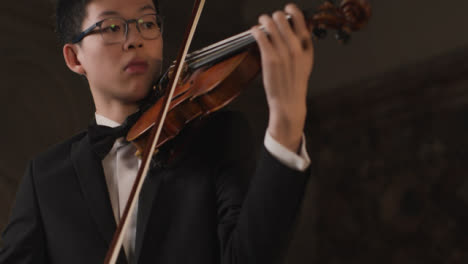 Pan-Up-Of-Male-Violinist-During-Performance