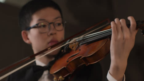 Camera-Move-From-Male-Violinist-To-Hands-Playing-Violin