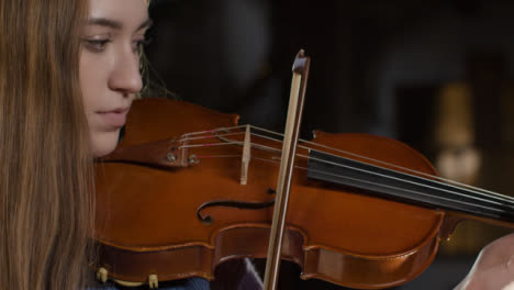 Side-View-Close-Up-Of-Female-Violinist-Playing