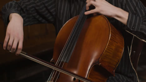 Tilt-Up-Close-Up-Male-Cellist-Playing