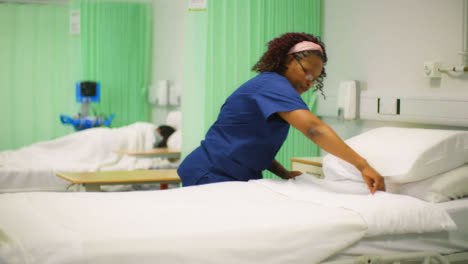 Nurse-Places-Pillow-on-Hospital-Bed