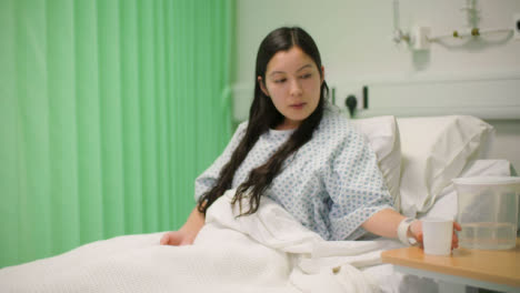Female-Patient-In-Hospital-Bed-Drinking-Water