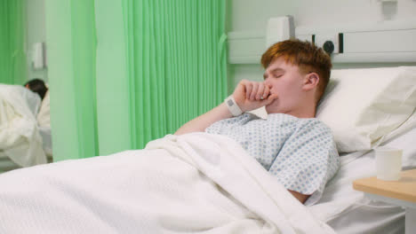 Male-Patient-Coughing-in-Hospital-Bed
