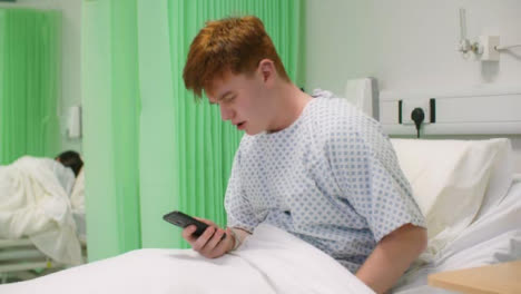 Concerned-Male-Hospital-Patient-Using-Phone