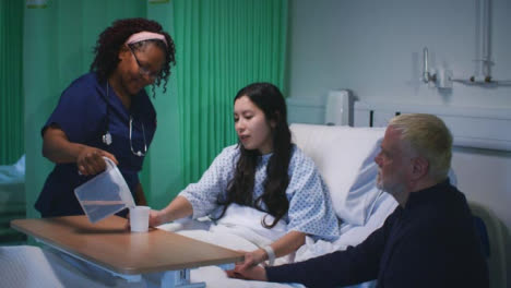 Female-Nurse-Gives-Patient-Some-Water