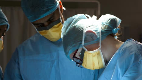 CU-Three-Surgeons-Looking-Down-At-Surgery