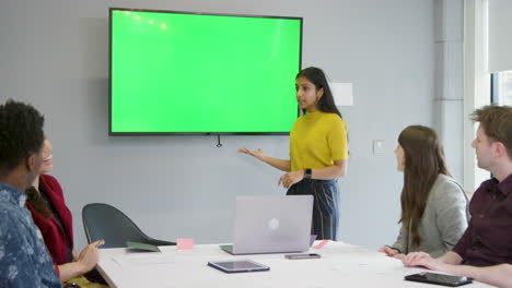 Woman-Presenting-To-Business-Colleagues-Using-Green-Screen
