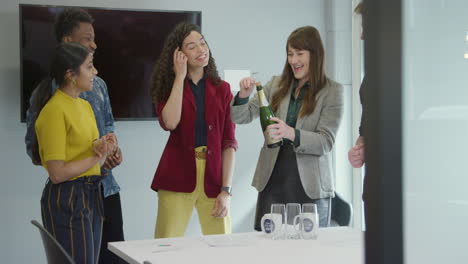 Business-Team-Celebrate-At-Work-With-Champagne