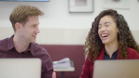 Man-And-Woman-Talking-And-Laughing-In-Office