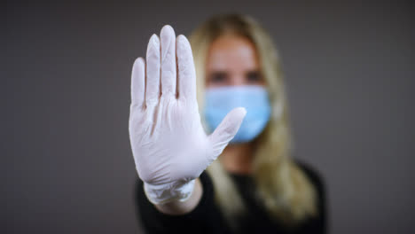 Woman-Uses-Stop-Gesture-with-Glove