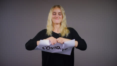 Young-Blonde-Woman-Rips-Covid-19-Sign